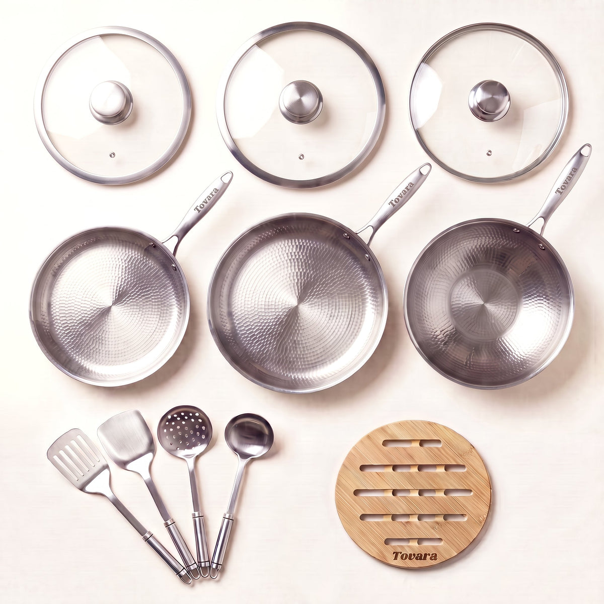 TitaniumPro Premium Pan Set: three pans, utensils, three glass lids and a bamboo trivet