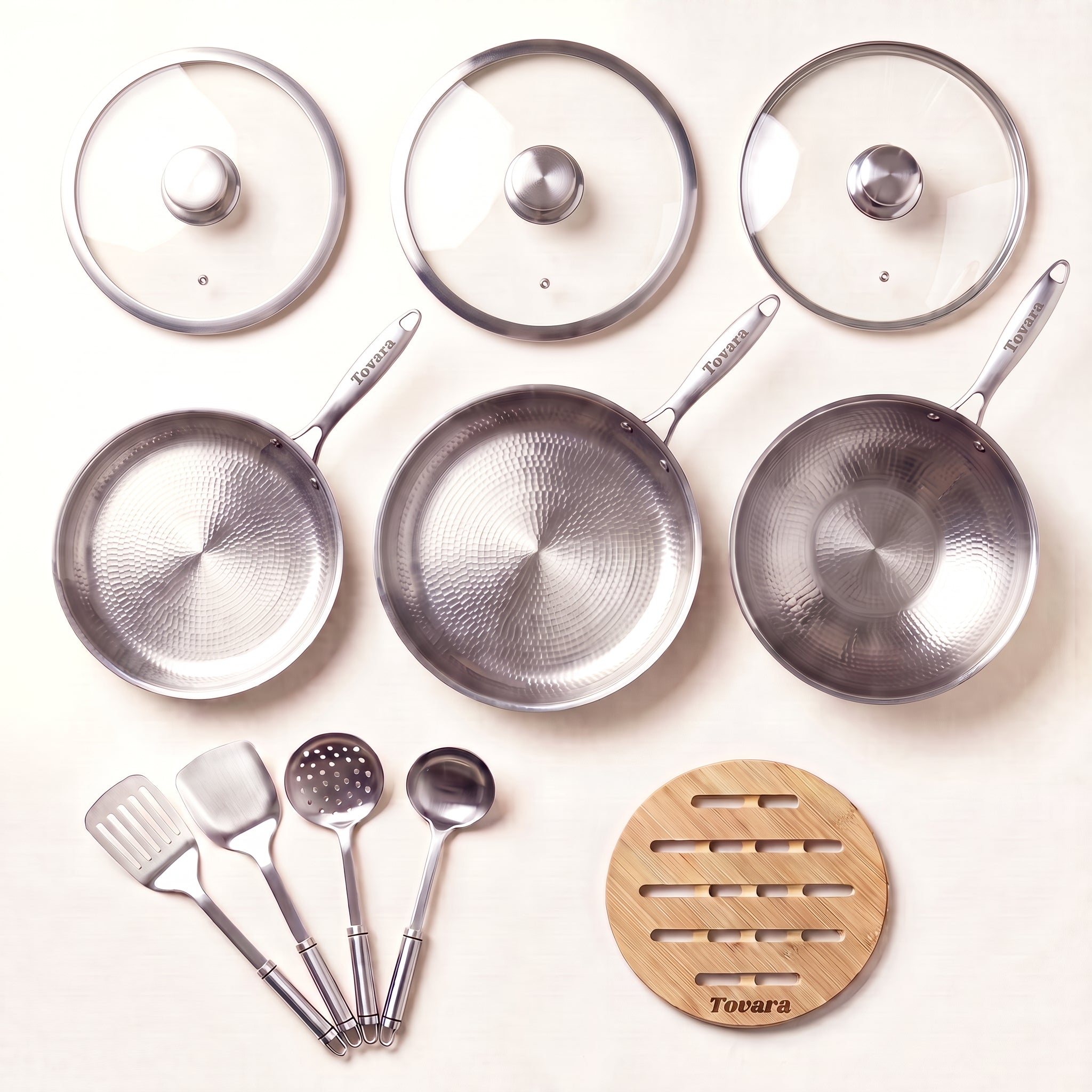 TitaniumPro Premium Pan Set: three pans, utensils, three glass lids and a bamboo trivet