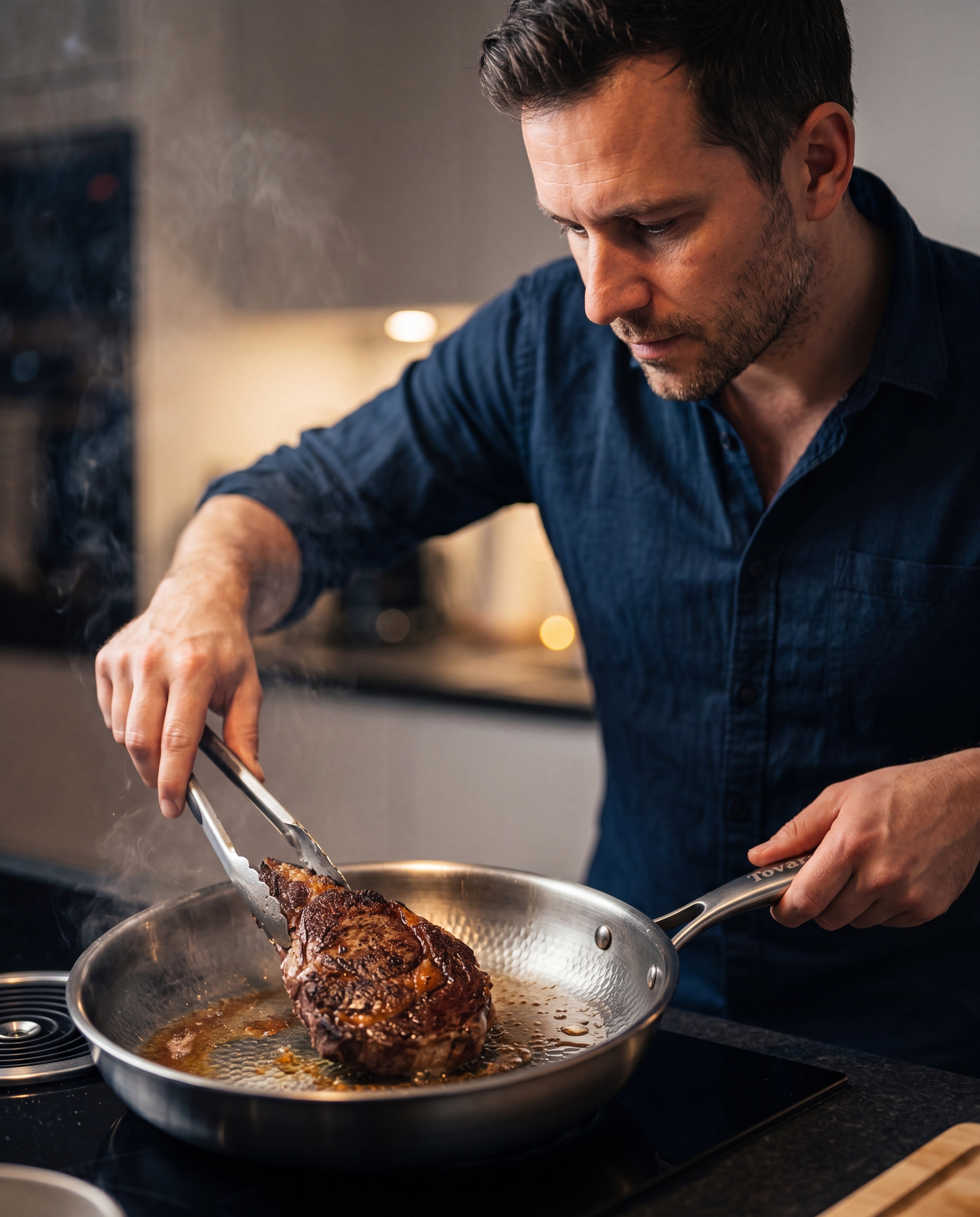 A man searing a steak in the TitaniumPro pan